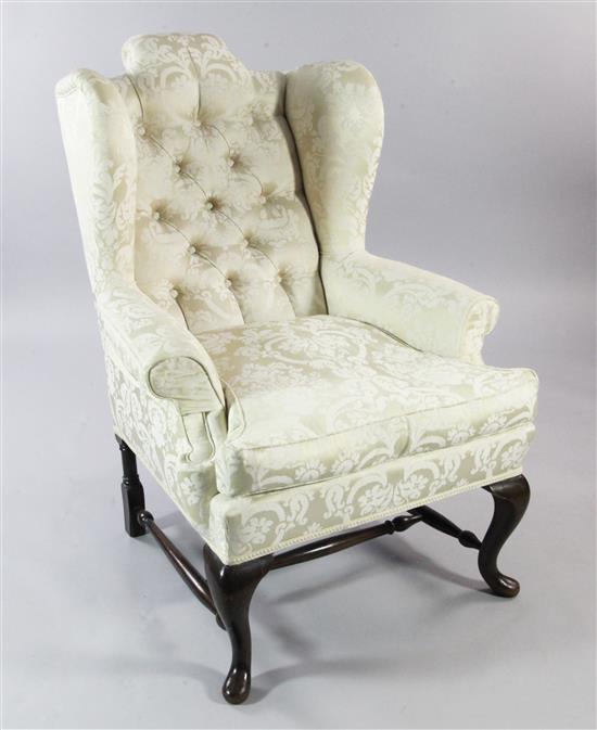 An 18th century style wingback armchair,